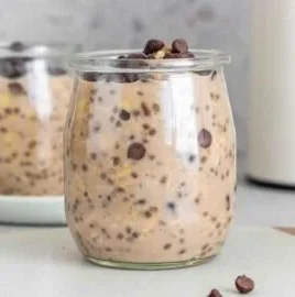 Bowl of chocolate protein overnight oats topped with fruits and nuts