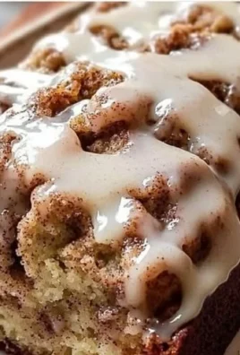 Slice of cinnamon roll banana bread topped with cream cheese icing