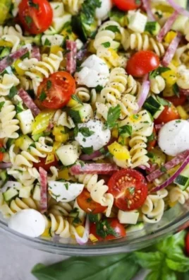 Colorful pasta salad with fresh vegetables and dressing