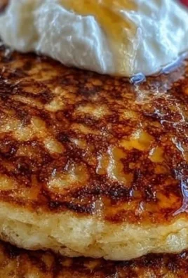 Fluffy cottage cheese pancakes served on a plate with syrup