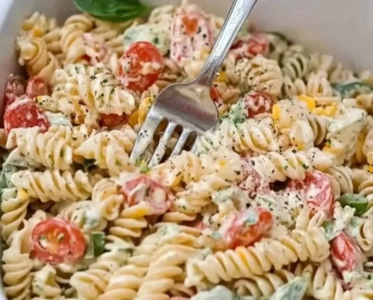 Creamy Italian pasta salad with fresh vegetables and herbs