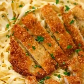 Delicious crispy chicken fettuccine Alfredo served on a plate