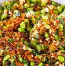 Crispy Rice Salad with fresh vegetables and herbs in a vibrant bowl