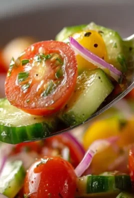 Fresh Cucumber Tomato Salad with herbs and dressing in a bowl
