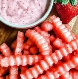 Delicious watermelon fries served with strawberry yogurt dip on a plate.