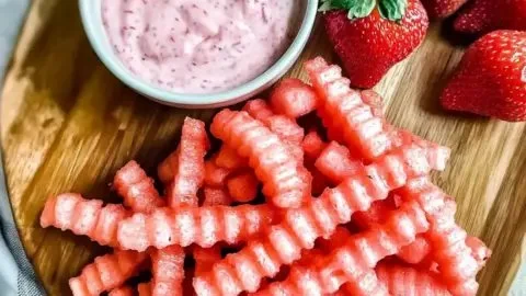 Delicious watermelon fries served with strawberry yogurt dip on a plate.