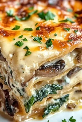 Creamy spinach mushroom lasagna layered with rich cheese and fresh ingredients