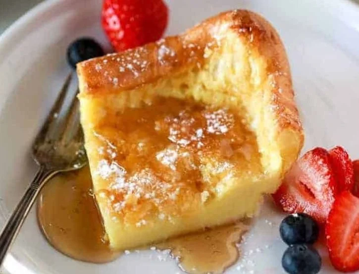 Fluffy easy German pancakes served with syrup and fruit