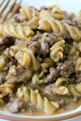 Gluten-free dairy-free beef stroganoff served in a bowl with herbs on top