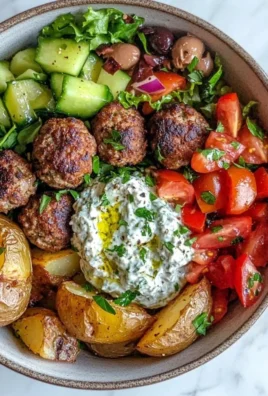 Delicious Greek Meatball Bowl with savory meatballs, veggies, and sauces.