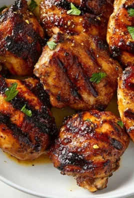 Juicy grilled chicken thighs seasoned and cooked to perfection on the grill.