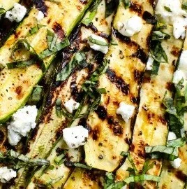 Grilled zucchini topped with goat cheese, basil, and honey
