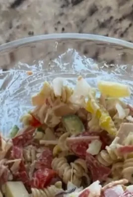 Colorful Grinder Pasta Salad with vegetables, cheese, and dressing for a fresh meal