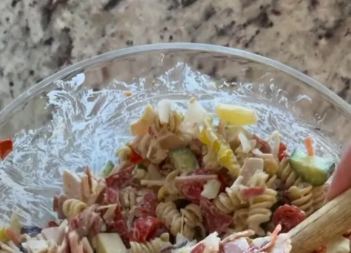 Colorful Grinder Pasta Salad with vegetables, cheese, and dressing for a fresh meal