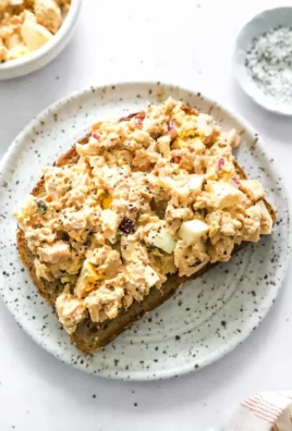 Bowl of healthy tuna egg salad with fresh ingredients and vibrant colors