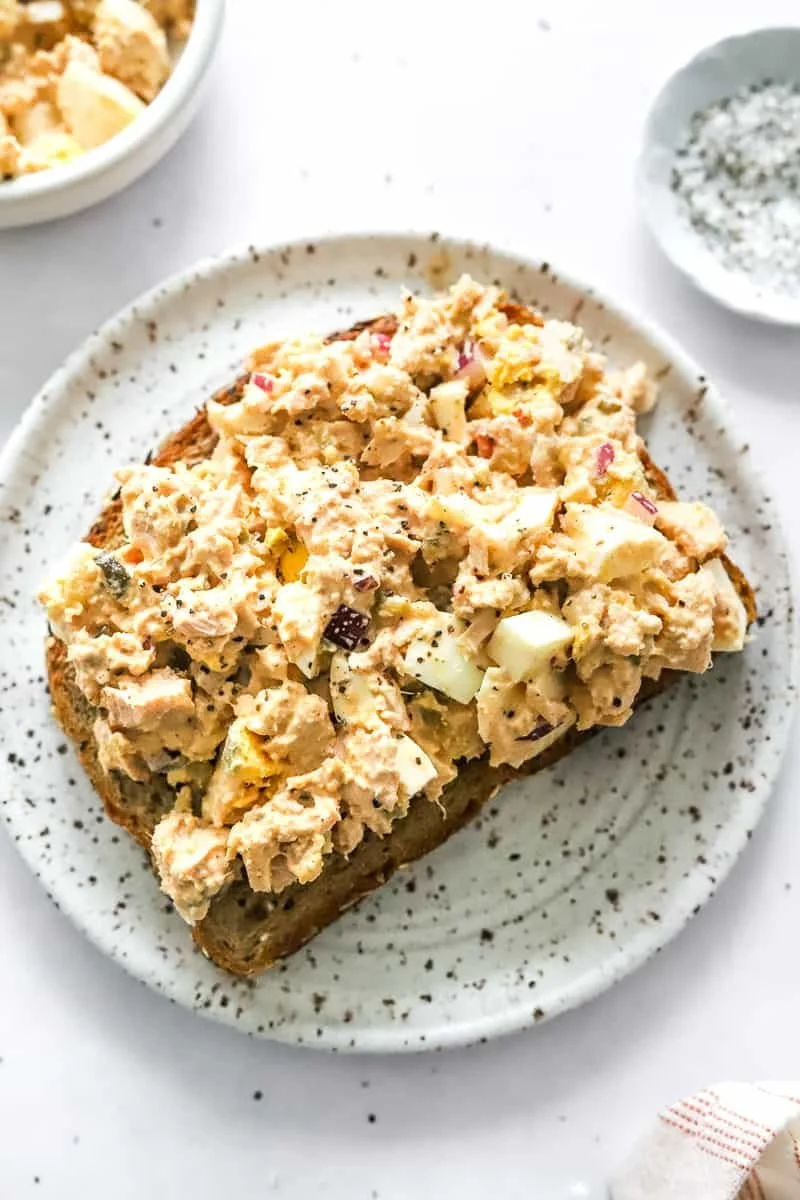 Bowl of healthy tuna egg salad with fresh ingredients and vibrant colors