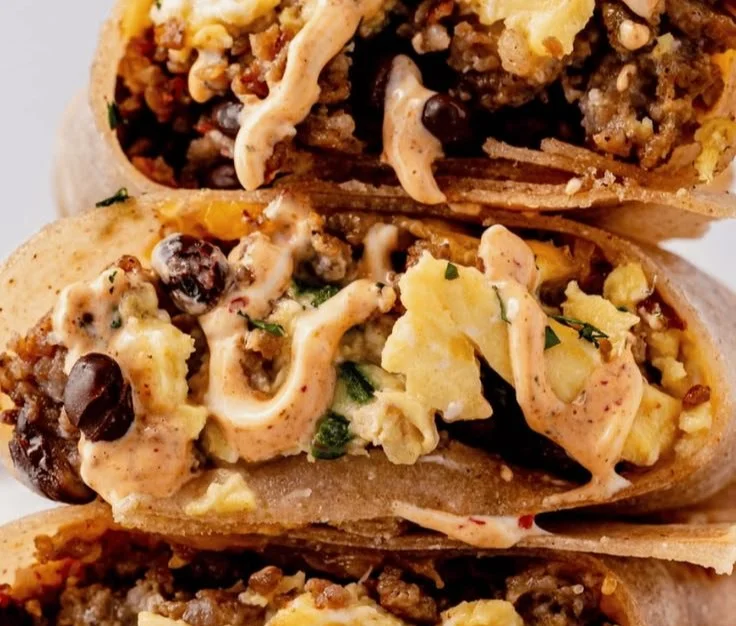 High-protein breakfast burrito wrapped in a tortilla with eggs and vegetables.