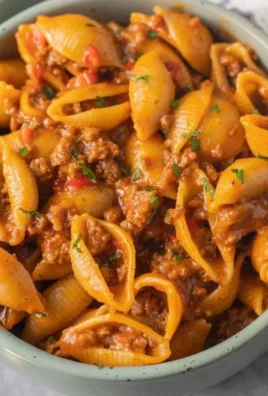 High protein taco pasta dish topped with fresh herbs and cheese