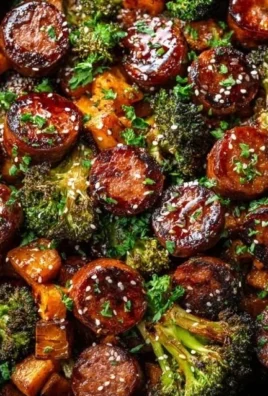 Honey garlic sausage alongside roasted sweet potatoes on a sheet pan dinner.