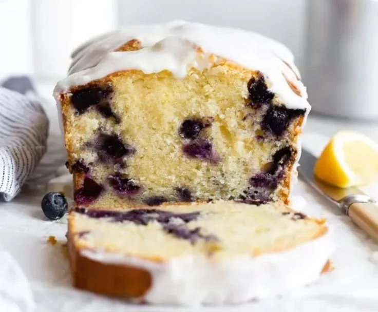 Slice of lemon blueberry pound cake topped with fresh blueberries
