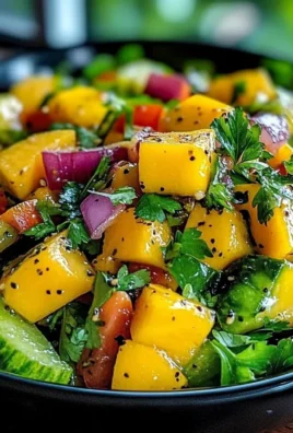 Mango salad with lime dressing, fresh ingredients and vibrant colors.