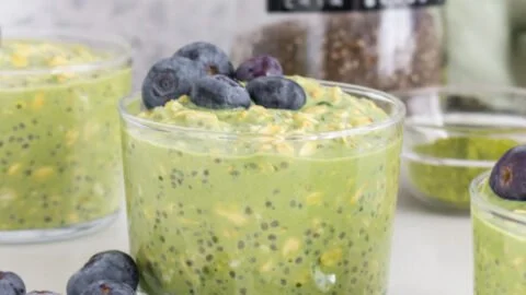 Bowl of matcha overnight oats topped with fruits and nuts
