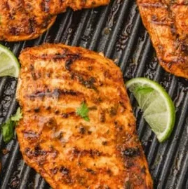Juicy Mexican chicken breast garnished with spices and herbs.