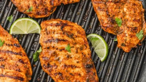 Juicy Mexican chicken breast garnished with spices and herbs.