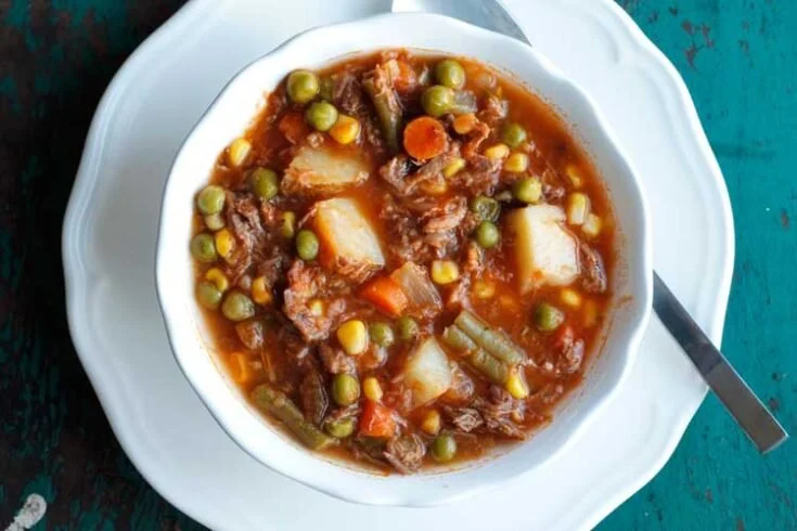 Bowl of my Mom's old-fashioned vegetable beef soup with fresh vegetables and beef