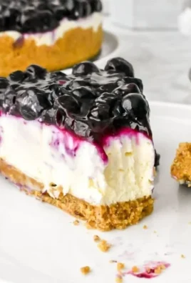 No bake blueberry cheesecake topped with fresh blueberries and whipped cream.