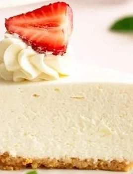 No Bake Cheesecake topped with fresh strawberries and mint garnish