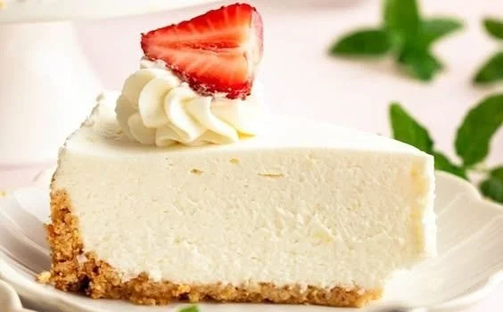 No Bake Cheesecake topped with fresh strawberries and mint garnish