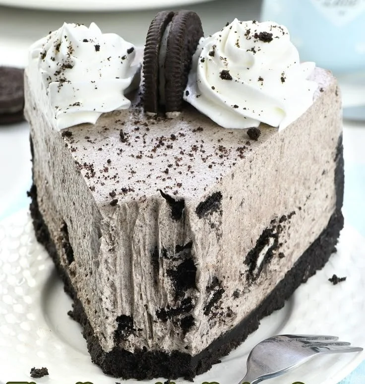 No-Bake Oreo Cheesecake topped with crushed Oreos and chocolate drizzle