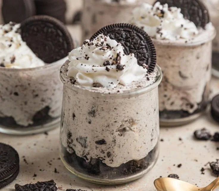 No bake Oreo cheesecake cups topped with crushed Oreo cookies.