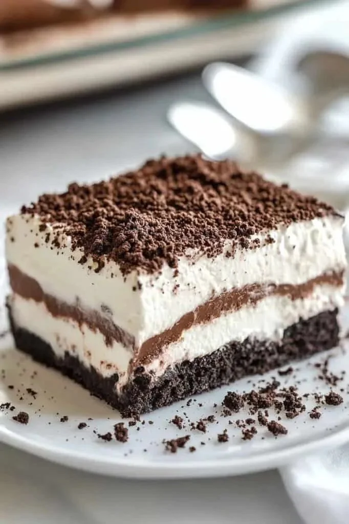 Delicious no bake Oreo lasagna dessert with layers of cream and Oreo cookies.