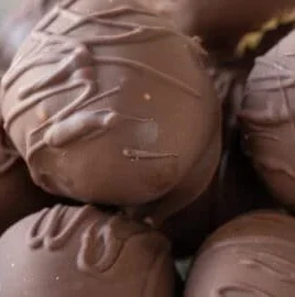 No bake peanut butter balls arranged on a plate, ready to enjoy.