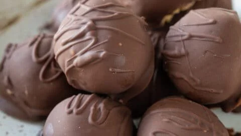 No bake peanut butter balls arranged on a plate, ready to enjoy.