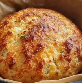 No knead cheddar bread baked in a Dutch oven, golden and crusty