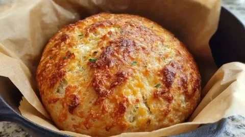 No knead cheddar bread baked in a Dutch oven, golden and crusty