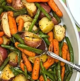 Oven-roasted vegetables with garlic and herbs on a baking sheet