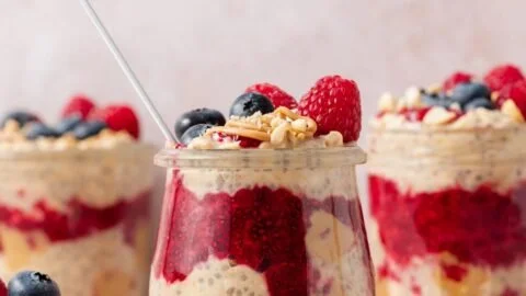 Peanut Butter and Jelly Overnight Oats in a glass jar with fresh strawberries