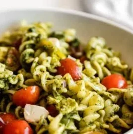 Delicious pesto pasta salad with colorful veggies and herbs