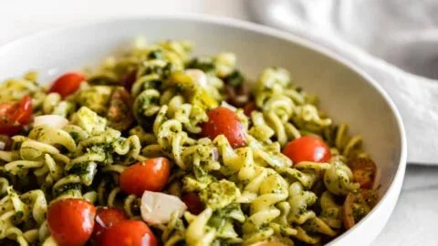 Delicious pesto pasta salad with colorful veggies and herbs