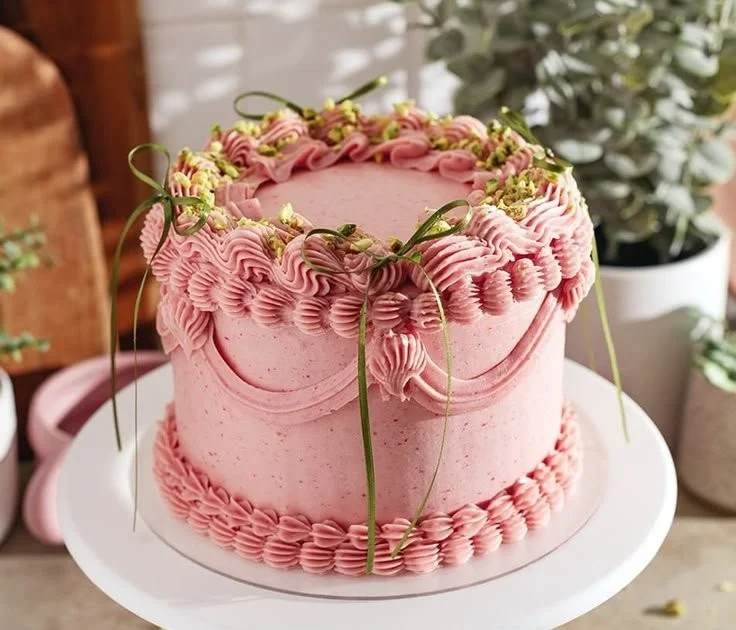 Delicious Pistachio Raspberry Cake with vibrant raspberry topping and nuts.