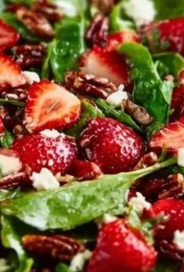 Spinach strawberry salad with pecans served in a bowl