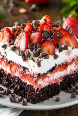 Strawberry Earthquake Cake topped with fresh strawberries and cream cheese swirl.
