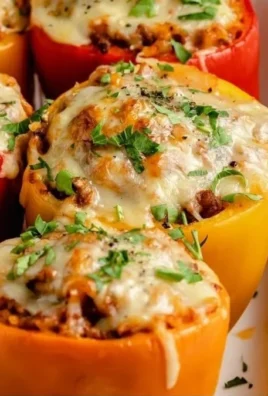 Colorful stuffed bell peppers filled with rice, vegetables, and spices.