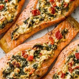 Stuffed salmon with spinach and feta served on a plate.