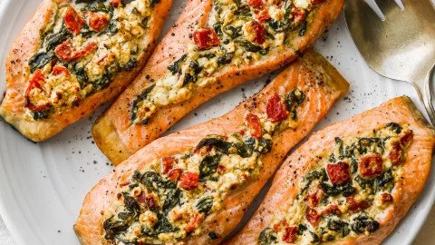 Stuffed salmon with spinach and feta served on a plate.