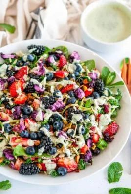 Superfood berry salad with creamy lemon herb dressing served in a bowl